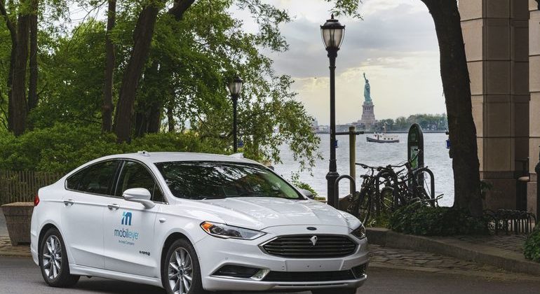 A_self-driving_vehicle_from_Mobileye’s_autonomous_test_fleet_sits_parked_across_from_the_Statue_of_Liberty_in_June_2021._Mobileye_tests_its_technology_in_complex_urban_areas_in_preparation_for_future_driverless_services._(Credit:_Mobileye,_an_Intel_Compan